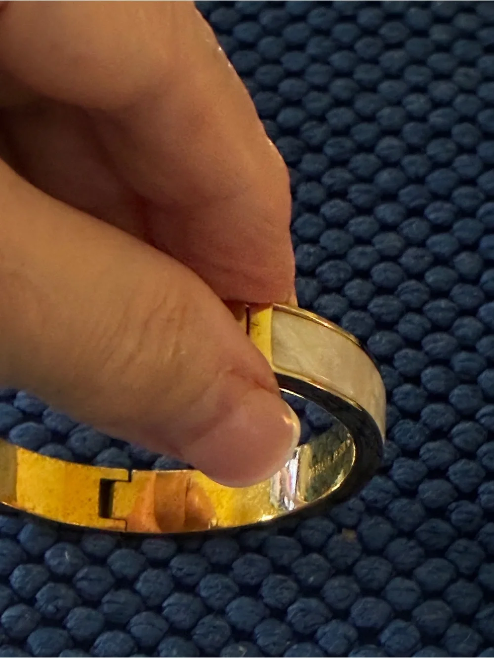 Kate Spade gold-tone bangle with cream enamel and heart detail